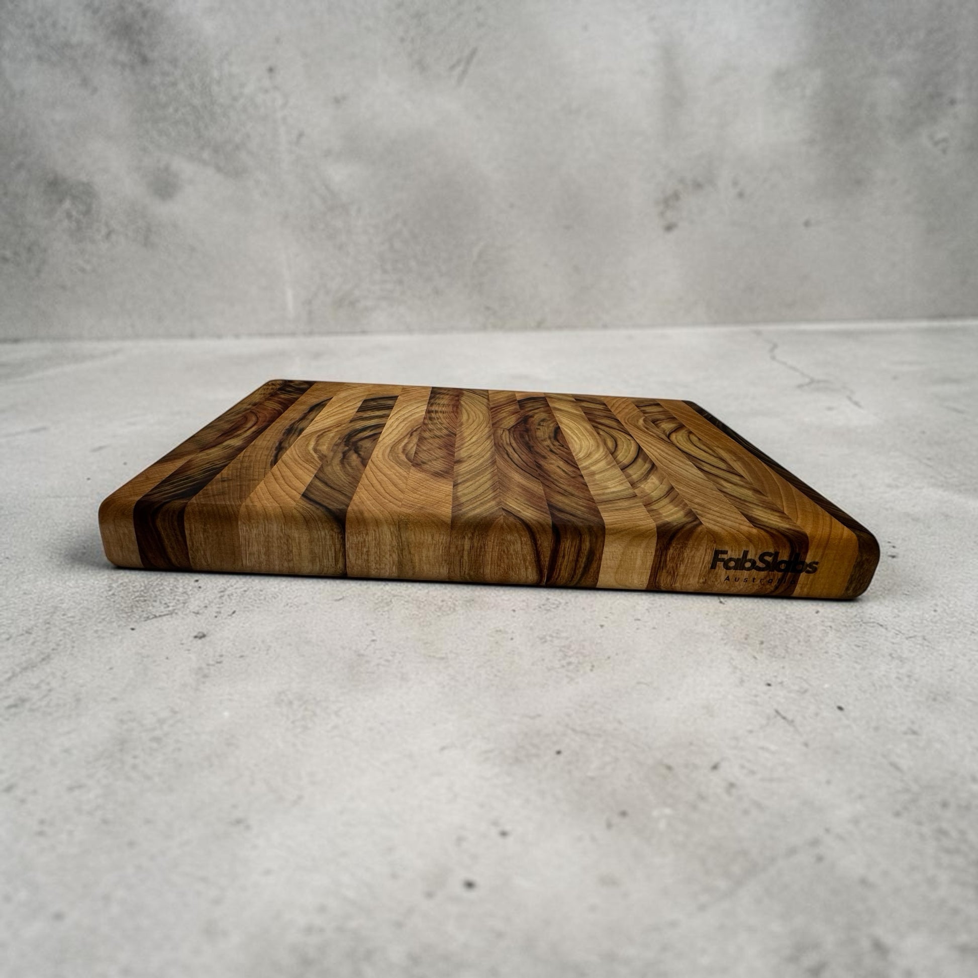 Fab Slabs Online Store premium Australian hardwood chopping board with a natural striped timber grain pattern.