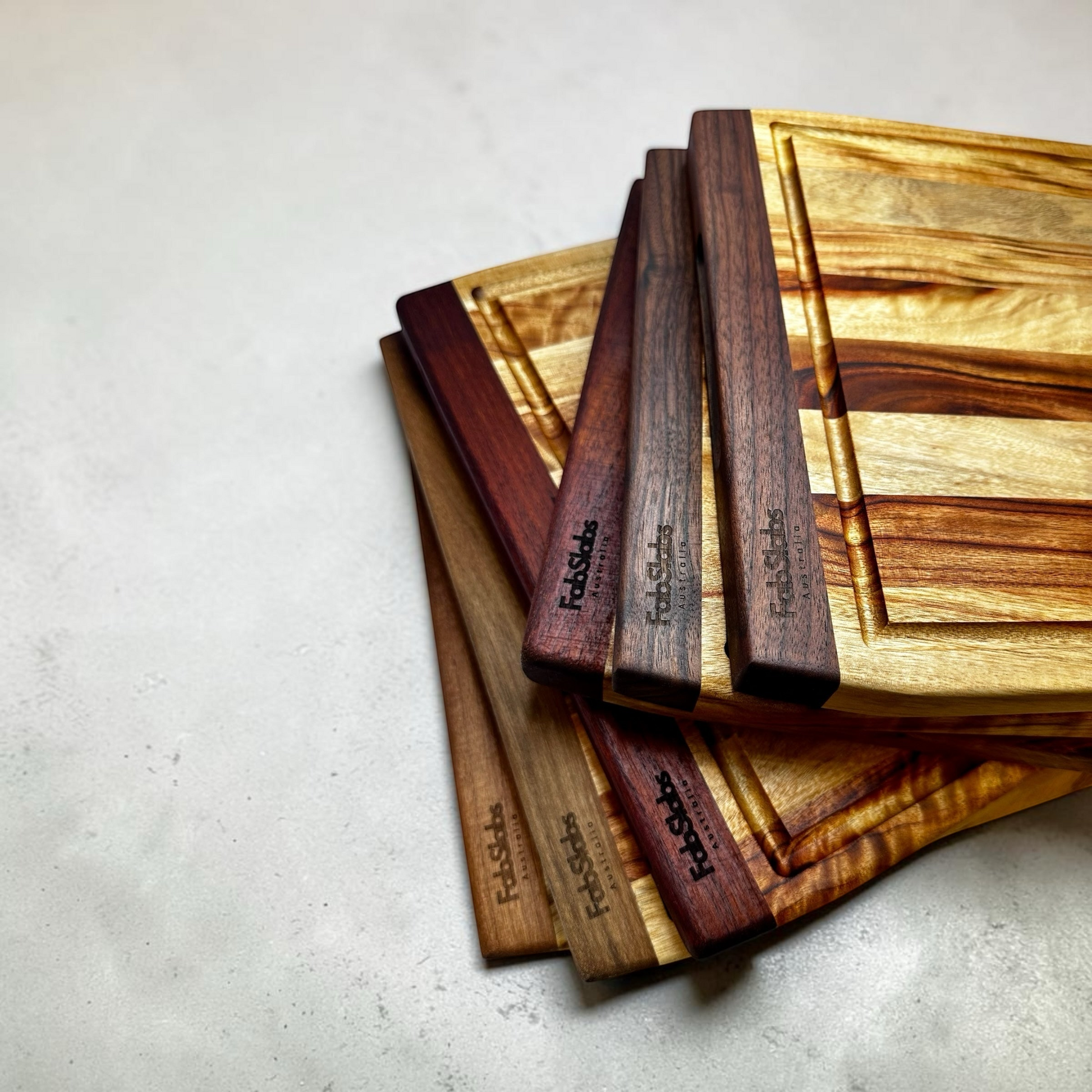Fab Slabs Online Store handcrafted timber cutting boards with rich grain patterns and integrated juice grooves